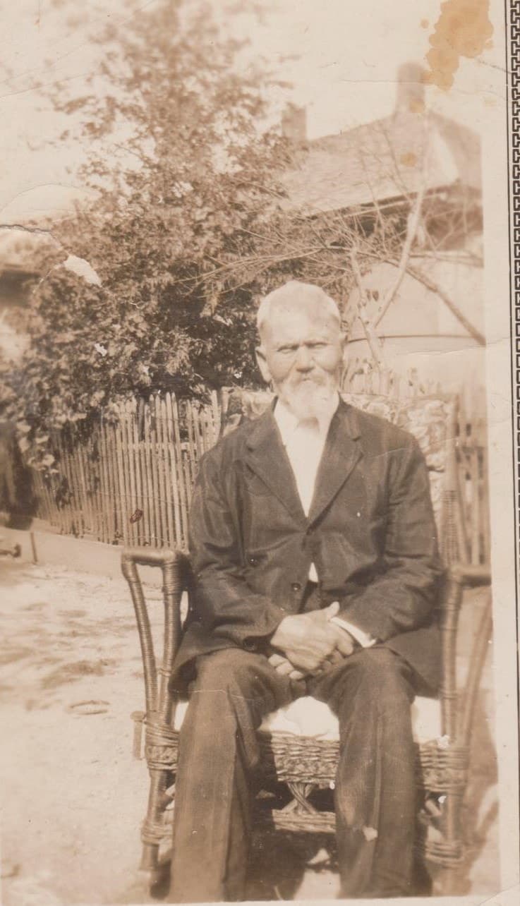 Full seated portrait attributed to Franklin Meason outside a family home