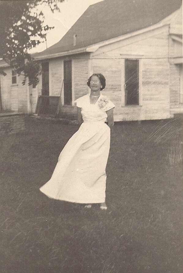 Full standing portrait attributed to Mary Estelle Sledge Meason outside a house
